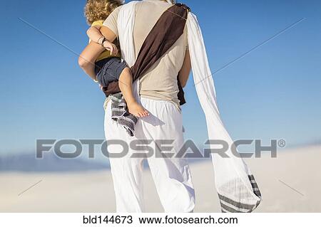 Caucasian mother holding son on sand dune View Large Photo Image Stock Image - Caucasian mother holding son on sand dune. Fotosearch