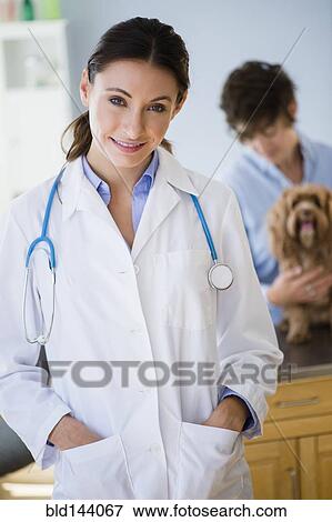 Caucasian veterinarian smiling in office View Large Photo Image Stock Photo - Caucasian veterinarian smiling in office. Fotosearch