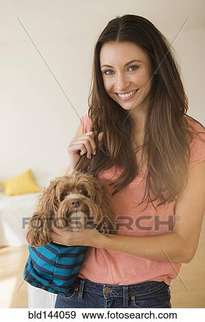 Caucasian woman holding pet dog View Large Photo Image Stock Photo - Caucasian woman holding pet dog. Fotosearch