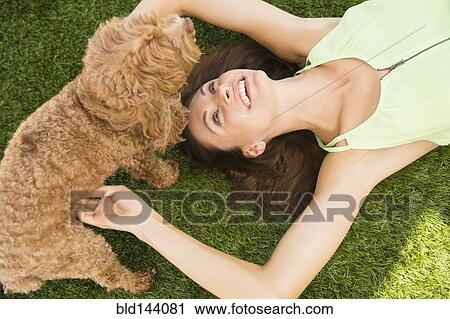 Caucasian woman playing with dog on lawn View Large Photo Image Stock Image - Caucasian woman playing with dog on lawn. Fotosearch