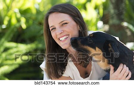 Caucasian woman playing with dog outdoors View Large Photo Image Picture - Caucasian woman playing with dog outdoors. Fotosearch