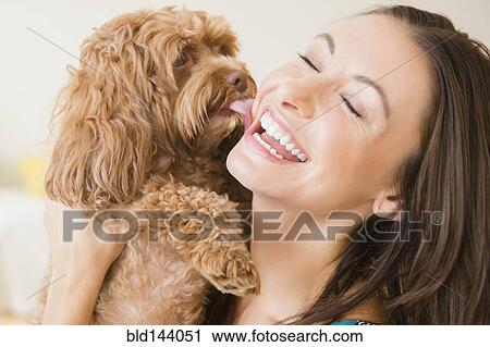 Caucasian woman playing with pet dog View Large Photo Image Stock Image - Caucasian woman playing with pet dog. Fotosearch