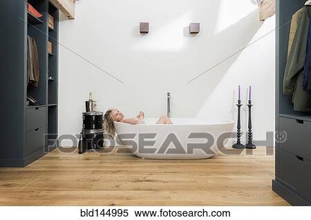 Caucasian woman relaxing in bathtub in modern bathroom View Large Photo Image Stock Photography - Caucasian woman relaxing in bathtub in modern bathroom. Fotosearch