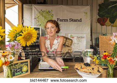 Caucasian woman selling fruit crumble and flowers at farmers market View Large Photo Image Stock Photo - Caucasian woman selling fruit crumble and flowers at farmers market. Fotosearch