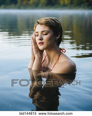 Caucasian woman sleeping in still lake View Large Photo Image Stock Photography - Caucasian woman sleeping in still lake. Fotosearch