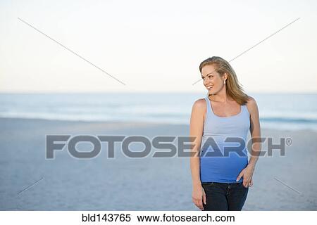 Stock Photography - Caucasian woman smiling on beach. Fotosearch