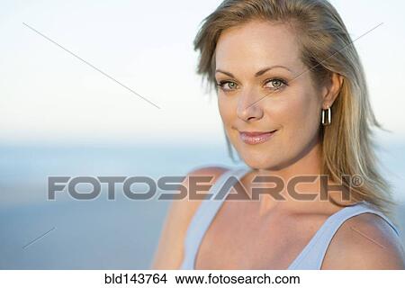 Picture - Caucasian woman smiling outdoors. Fotosearch