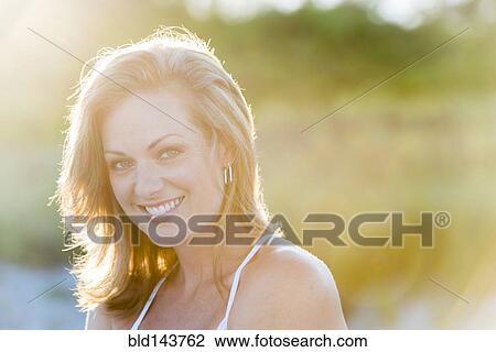 Caucasian woman smiling outdoors View Large Photo Image Stock Image - Caucasian woman smiling outdoors. Fotosearch