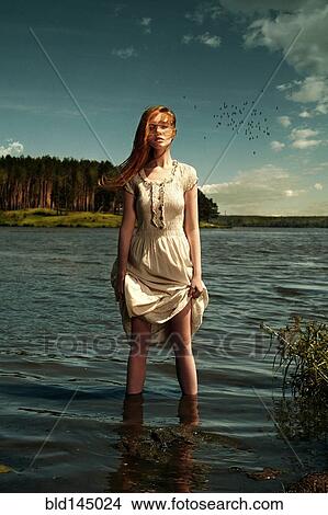 Caucasian woman standing in remote lake View Large Photo Image Picture - Caucasian woman standing in remote lake. Fotosearch