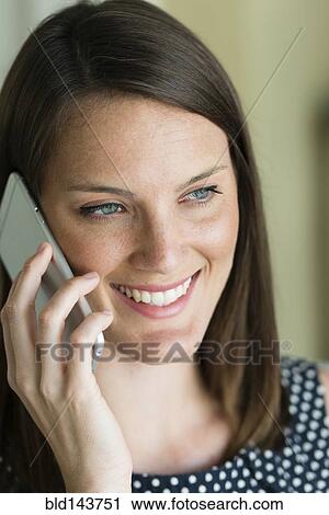 Stock Image - Caucasian woman talking on cell phone. Fotosearch