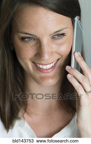 Stock Image - Caucasian woman talking on cell phone. Fotosearch