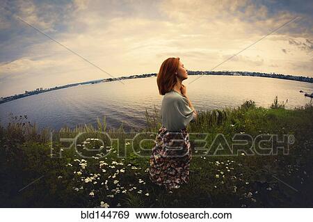Caucasian woman walking near lake View Large Photo Image Stock Photo - Caucasian woman walking near lake. Fotosearch