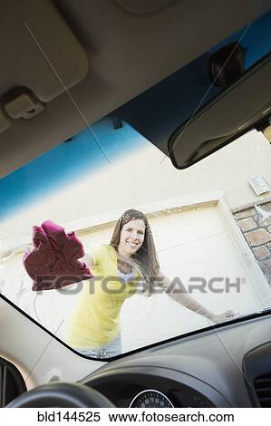 Caucasian woman washing car windshield View Large Photo Image Stock Photography - Caucasian woman washing car windshield. Fotosearch