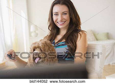 Caucasian woman watching television with pet dog View Large Photo Image Stock Image - Caucasian woman watching television with pet dog. Fotosearch