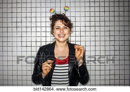 Caucasian woman wearing colorful antenna near wall View Large Photo Image Picture - Caucasian woman wearing colorful antenna near wall. Fotosearch