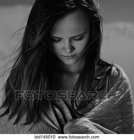 Stock Image - Caucasian woman wrapped in blanket. Fotosearch