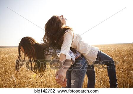 Caucasian women playing in rural field View Large Photo Image Stock Image - Caucasian women playing in rural field. Fotosearch