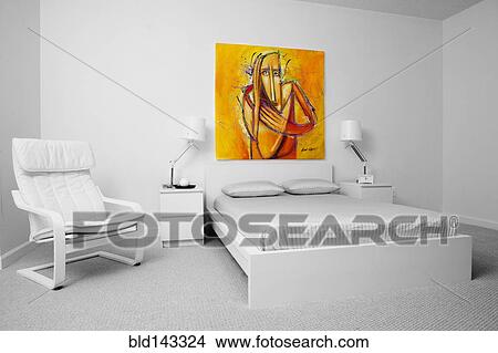 Picture - Chair, wall art and bed in modern bedroom. Fotosearch