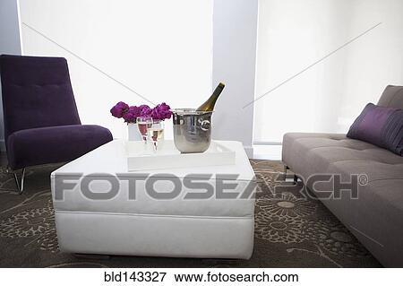 Stock Photo - Champagne on coffee table in modern living room. Fotosearch