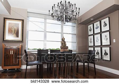 Chandelier over table in modern dining room View Large Photo Image Stock Photo - Chandelier over table in modern dining room. Fotosearch
