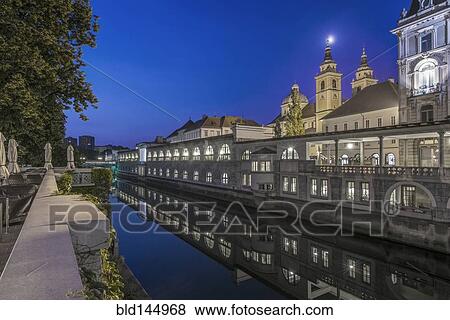 Stock Photo - Church and walkways near urban canal, Ljubljana, Central Slovenia, Slovenia. Fotosearch
