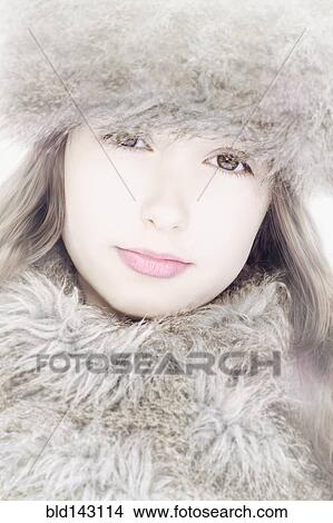 Picture - Close up of Caucasian girl wearing fur hat and scarf. Fotosearch