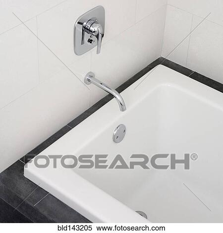 Stock Photography - Close up of faucet and bathtub in modern bathroom. Fotosearch