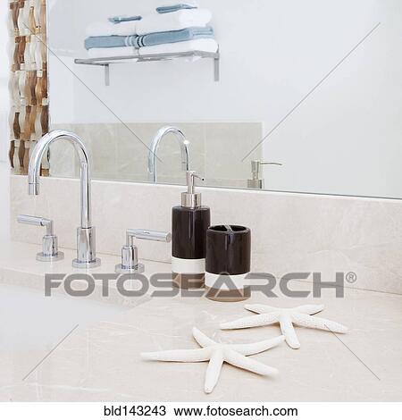 Stock Image - Close up of faucet, sink and mirror in modern bathroom. Fotosearch