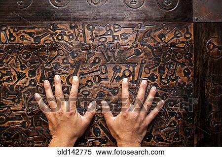 Stock Photography - Close up of hands of Mari man hands on wooden surface. Fotosearch
