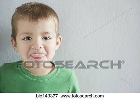 Close up of mixed race boy sticking out tongue View Large Photo Image Stock Photo - Close up of mixed race boy sticking out tongue. Fotosearch