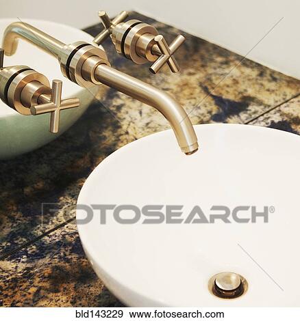 Stock Photo - Close up of sink and faucet in modern bathroom. Fotosearch