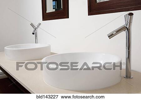 Close up of sinks and faucets in modern bathroom View Large Photo Image Stock Photo - Close up of sinks and faucets in modern bathroom. Fotosearch