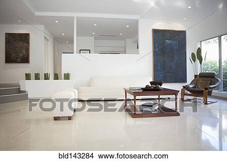 Coffee table, chairs and walls in modern living space View Large Photo Image Picture - Coffee table, chairs and walls in modern living space. Fotosearch