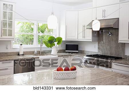 Stock Image - Counter, stove and sink in modern kitchen. Fotosearch