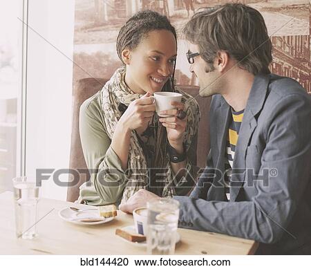 Stock Image - Couple drinking coffee in cafe. Fotosearch