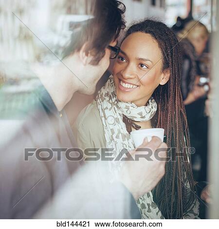 Stock Image - Couple drinking coffee in cafe. Fotosearch