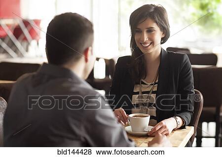 Stock Photo - Couple drinking coffee in cafe. Fotosearch