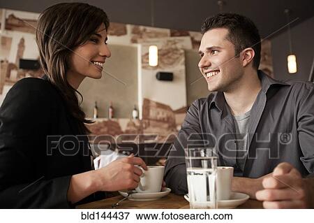 Stock Photo - Couple drinking coffee in cafe. Fotosearch