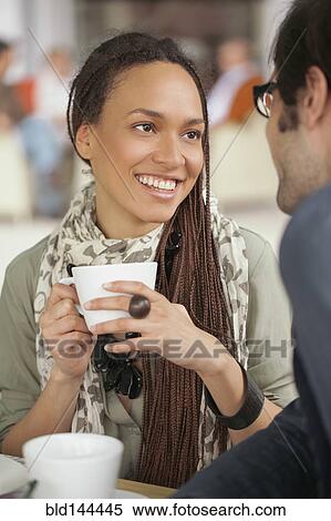 Stock Photography - Couple drinking coffee in cafe. Fotosearch