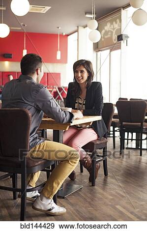 Stock Photo - Couple drinking coffee together in cafe. Fotosearch