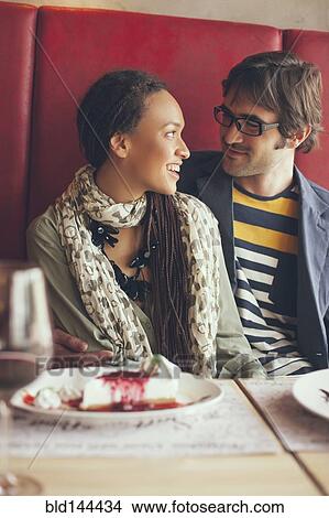 Couple eating dessert in cafe View Large Photo Image Picture - Couple eating dessert in cafe. Fotosearch