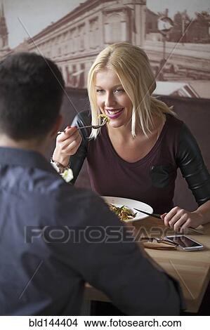 Picture - Couple eating in cafe. Fotosearch