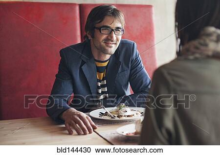 Stock Image - Couple eating in cafe. Fotosearch
