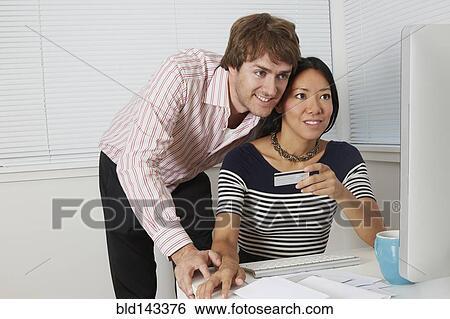 Stock Photograph - Couple shopping online together. Fotosearch