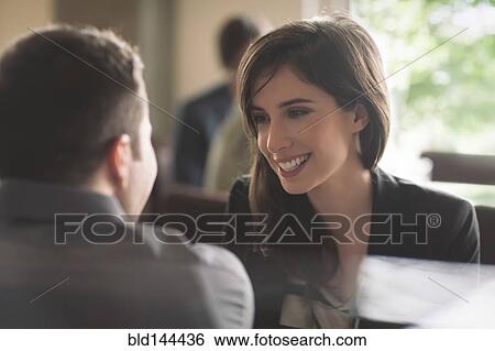 Stock Photograph - Couple talking in cafe. Fotosearch