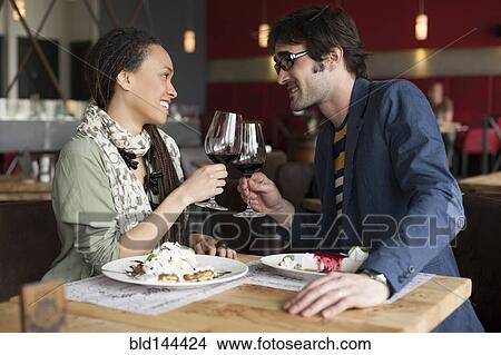 Couple toasting with wine in cafe View Large Photo Image Picture - Couple toasting with wine in cafe. Fotosearch