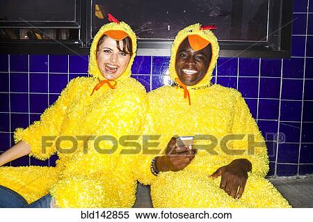 Couple wearing chicken costumes indoors View Large Photo Image Stock Photography - Couple wearing chicken costumes indoors. Fotosearch