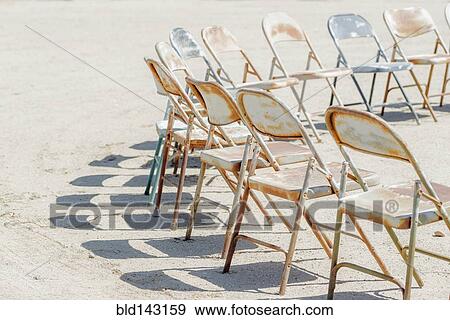 Dilapidated chairs arranged in circle in dirt field View Large Photo Image Stock Photo - Dilapidated chairs arranged in circle in dirt field. Fotosearch