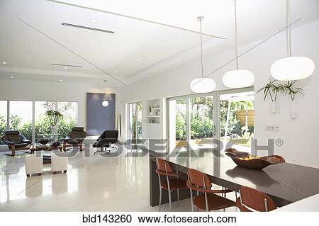 Dining table and living room in open living space View Large Photo Image Stock Image - Dining table and living room in open living space. Fotosearch