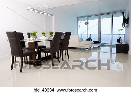 Picture - Dining table and sofas in modern living space. Fotosearch
